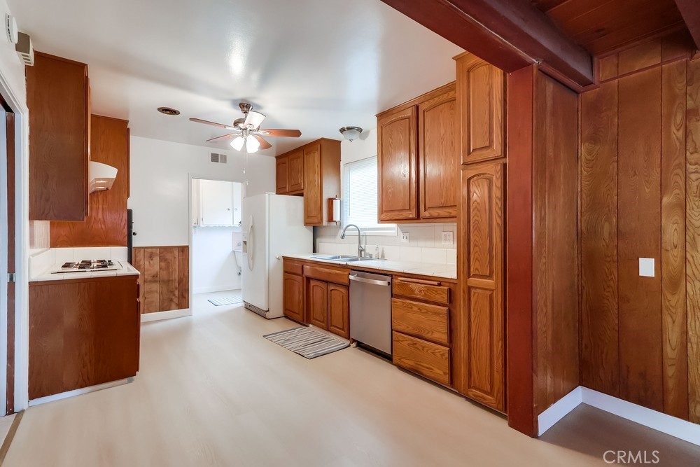 11639 Harvard Drive Norwalk, CA 90650 - Photo 11 of 33 a large kitchen with cabinets and stainless steel appliances