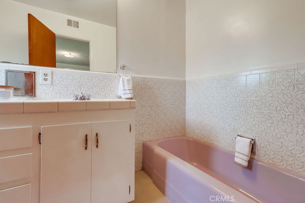 11639 Harvard Drive Norwalk, CA 90650 - Photo 24 of 33 a bathroom with a bathtub sink vanity and mirror