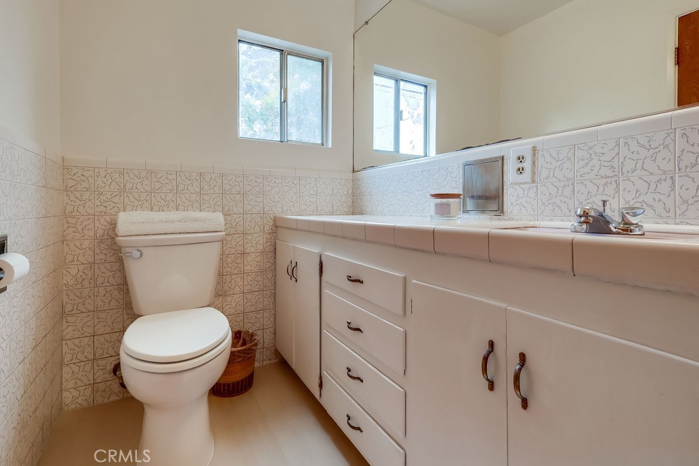 11639 Harvard Drive Norwalk, CA 90650 - Photo 25 of 33 a bathroom with a toilet a sink and mirror