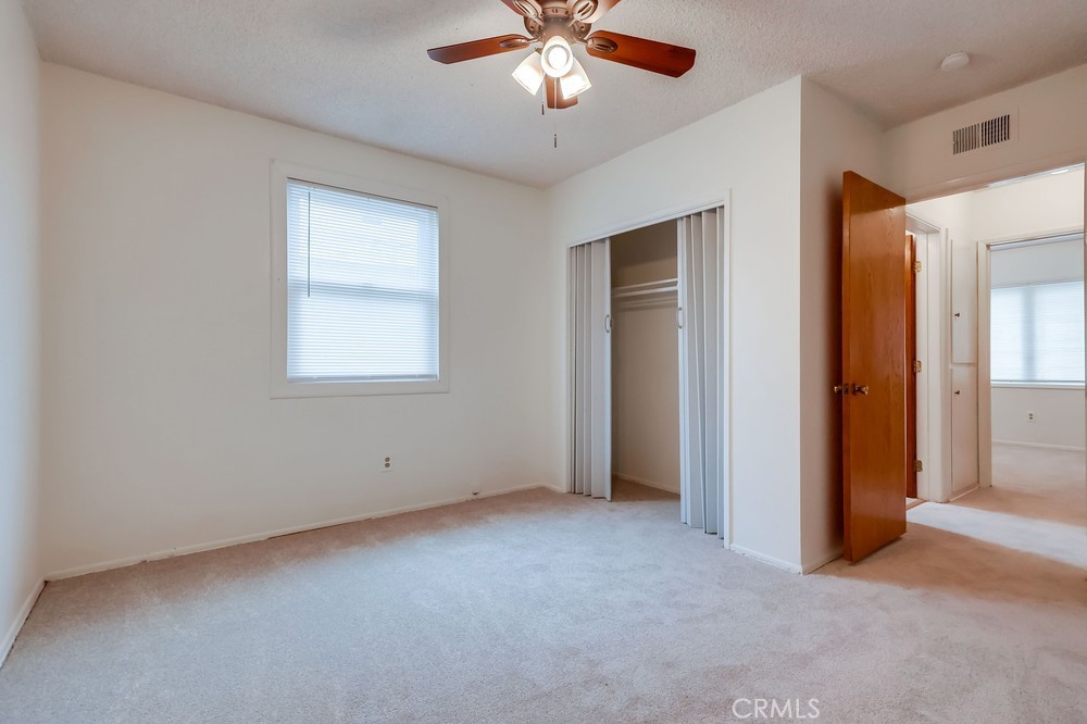 11639 Harvard Drive Norwalk, CA 90650 - Photo 30 of 33 an empty room with chandelier fan and windows