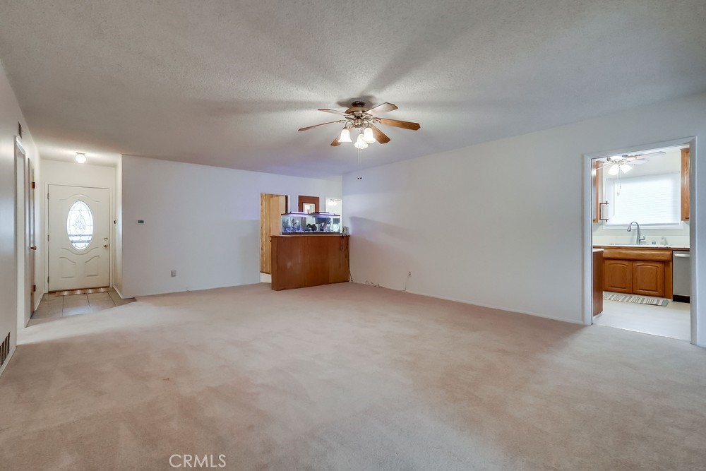 11639 Harvard Drive Norwalk, CA 90650 - Photo 4 of 33 an empty room with chandelier fan and windows