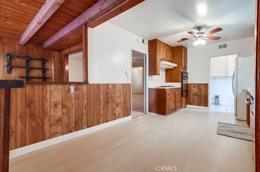 11639 Harvard Drive Norwalk, CA 90650 - Photo 10 of 33 a kitchen with stainless steel appliances kitchen island granite countertop a refrigerator and a stove top oven