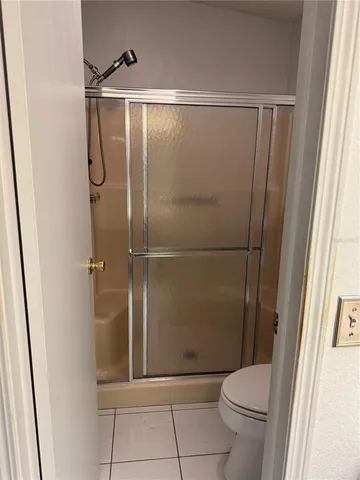 a bathroom with a shower and a toilet