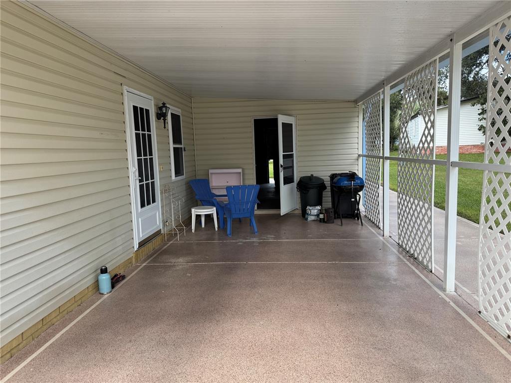 1605 Cherry Hill Road Lady Lake, FL 32159 - Photo 2 of 14 a view of a porch with furniture and floor to ceiling window