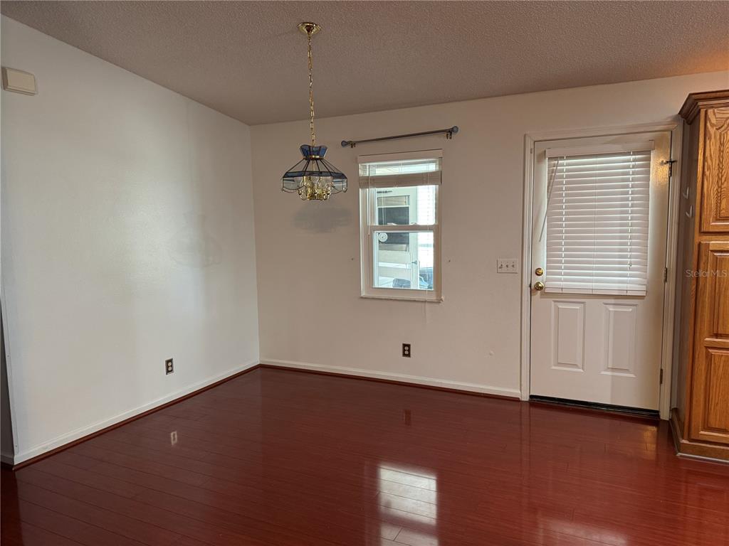 1605 Cherry Hill Road Lady Lake, FL 32159 - Photo 4 of 14 an empty room with a window and wooden floor