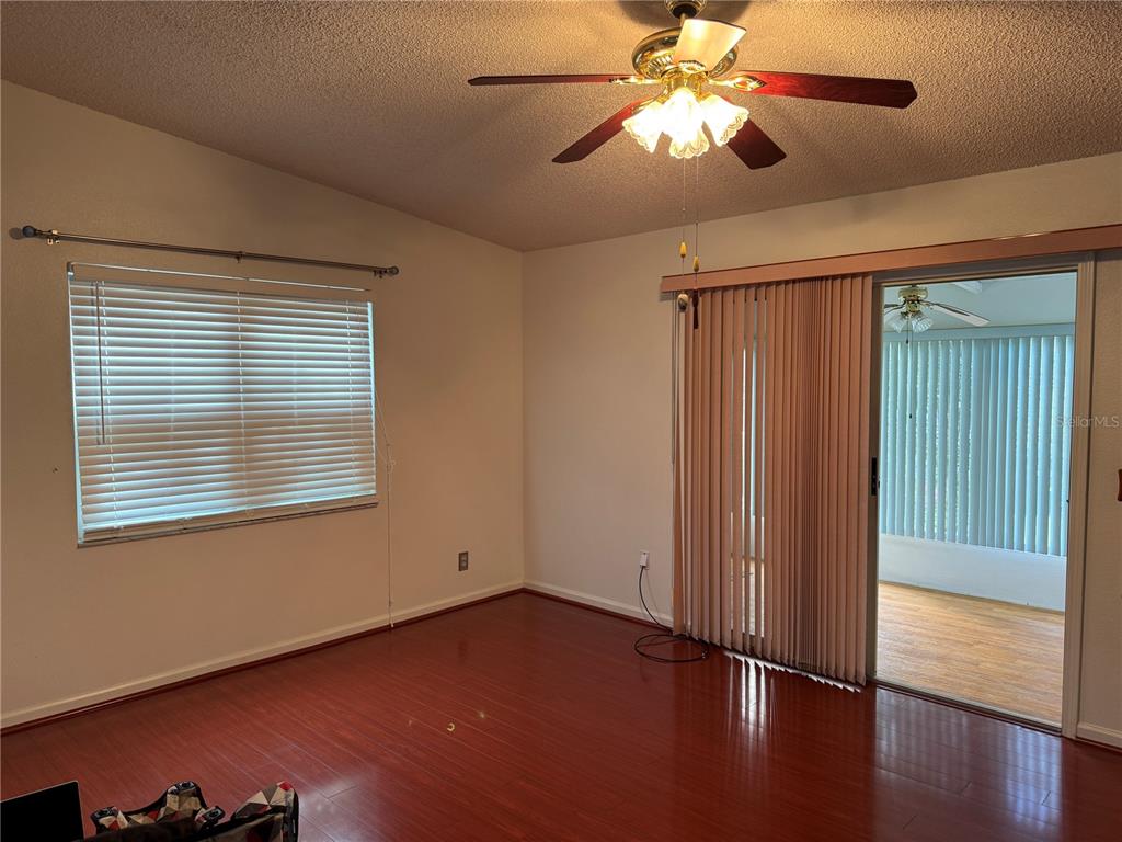 1605 Cherry Hill Road Lady Lake, FL 32159 - Photo 5 of 14 a view of an empty room with wooden floor and a window