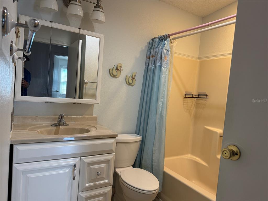 1605 Cherry Hill Road Lady Lake, FL 32159 - Photo 9 of 14 a bathroom with a granite countertop sink toilet and shower