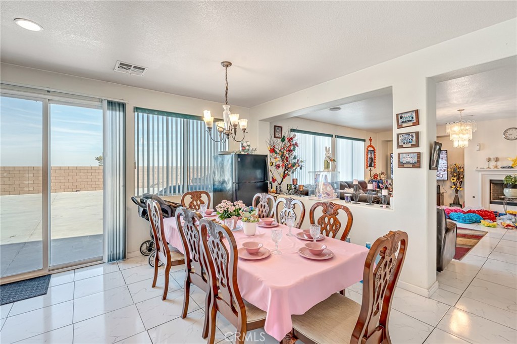 11036 Windcrest Court Adelanto, CA 92301 - Photo 13 of 45 a view of a dining room with furniture window and outside view
