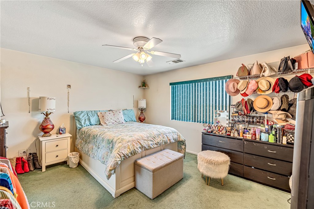 11036 Windcrest Court Adelanto, CA 92301 - Photo 17 of 45 a bedroom with a bed and a window