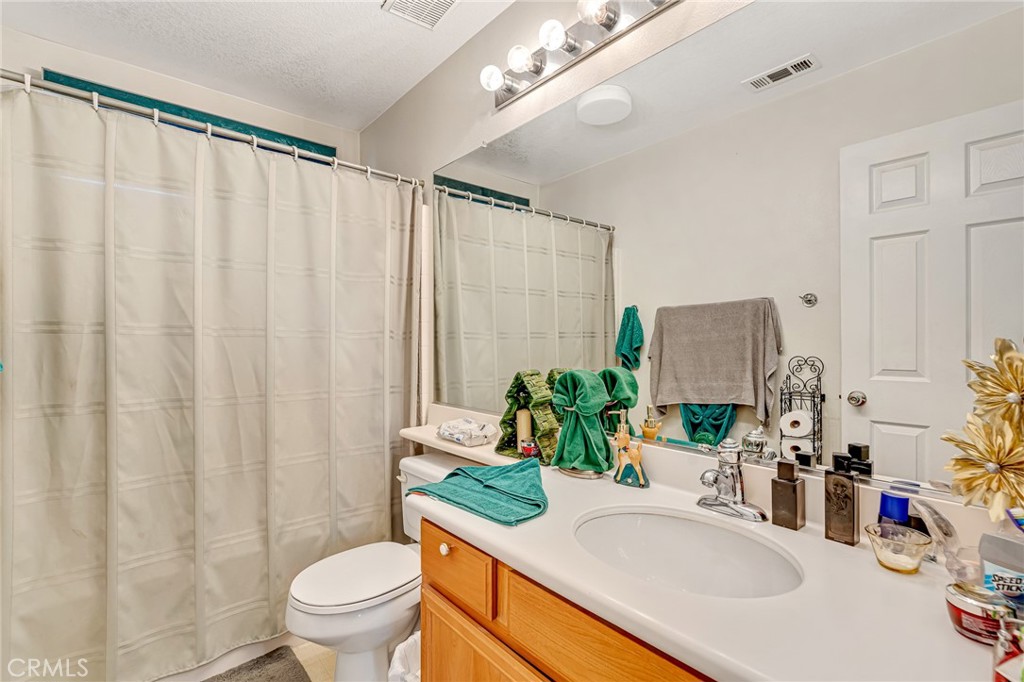 11036 Windcrest Court Adelanto, CA 92301 - Photo 19 of 45 a bathroom with a sink toilet and shower