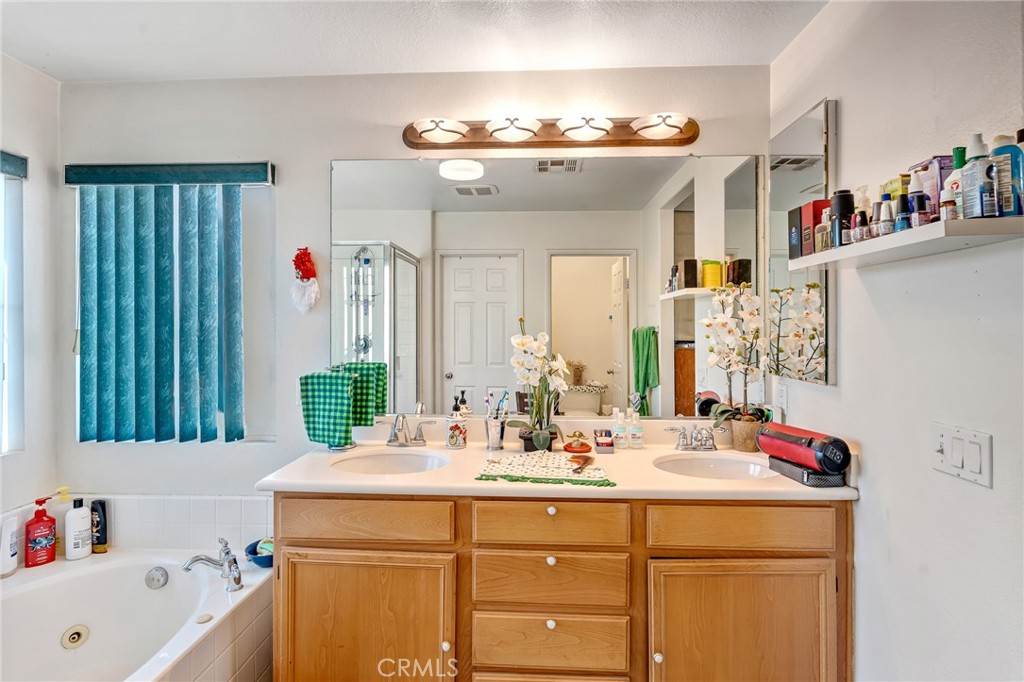 11036 Windcrest Court Adelanto, CA 92301 - Photo 20 of 45 a bathroom with a sink and a mirror