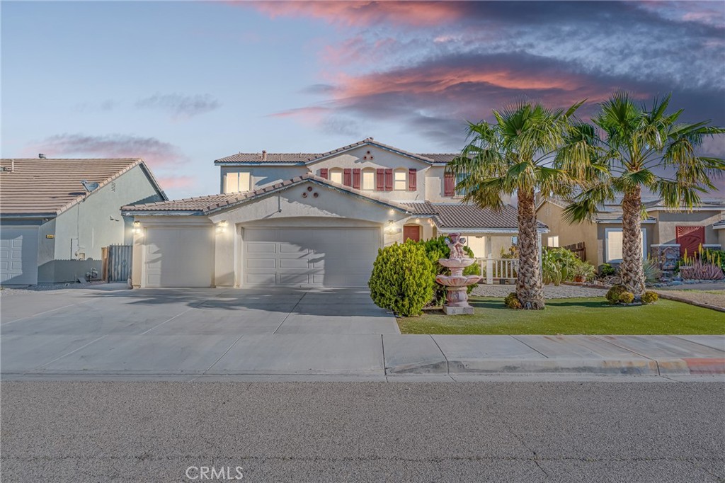 11036 Windcrest Court Adelanto, CA 92301 - Photo 2 of 45 front view of a house with a yard and a car parked in front of it
