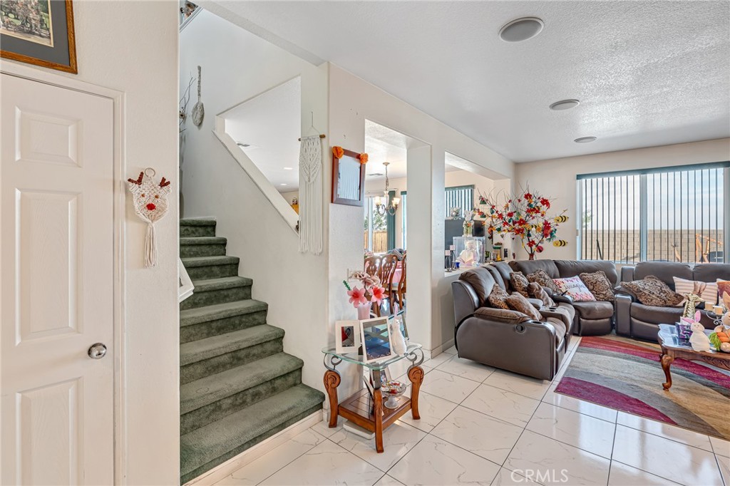 11036 Windcrest Court Adelanto, CA 92301 - Photo 25 of 45 a view of a livingroom with furniture and a potted plant