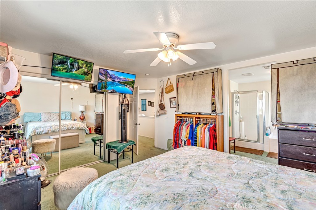11036 Windcrest Court Adelanto, CA 92301 - Photo 27 of 45 a bedroom with a bed and a walk in closet