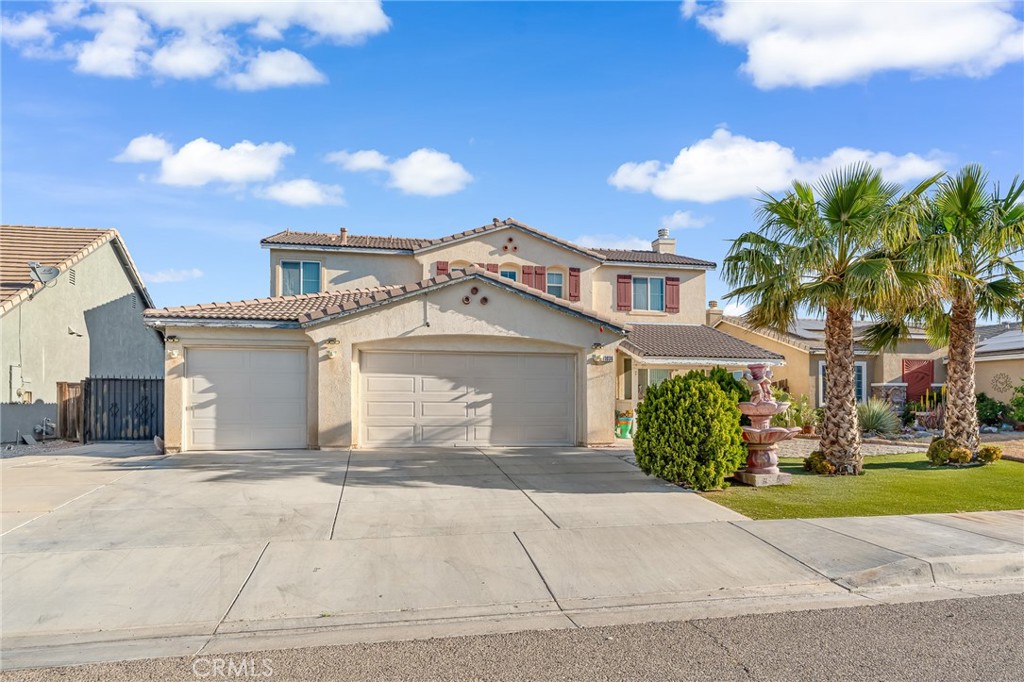 11036 Windcrest Court Adelanto, CA 92301 - Photo 37 of 45 a front view of a house with a yard and potted plants