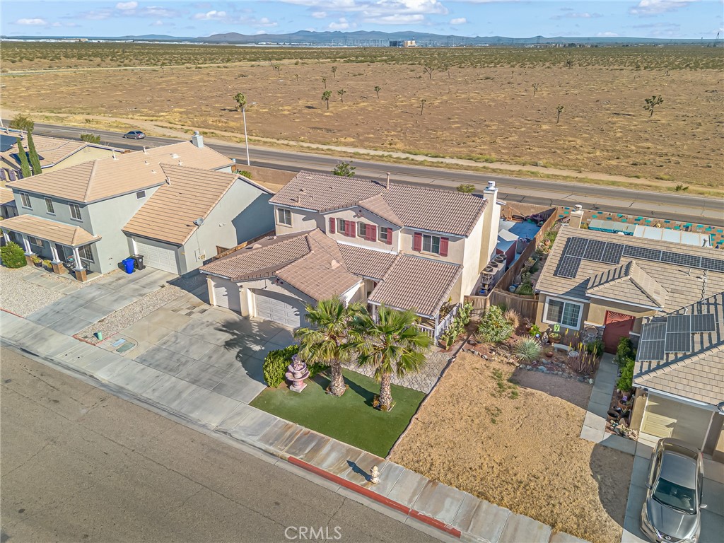 11036 Windcrest Court Adelanto, CA 92301 - Photo 40 of 45 an aerial view of residential houses with outdoor space and ocean view