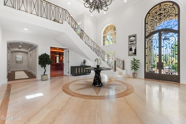 a view of entryway and hall with a front door
