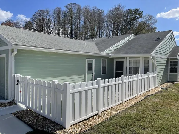 a view of a house with wooden fence