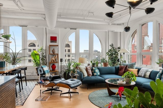 a living room with patio furniture and a large window