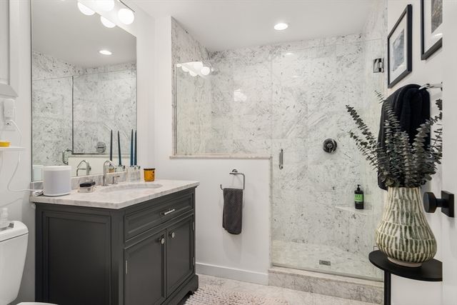a living room with furniture ceiling fan and a large window
