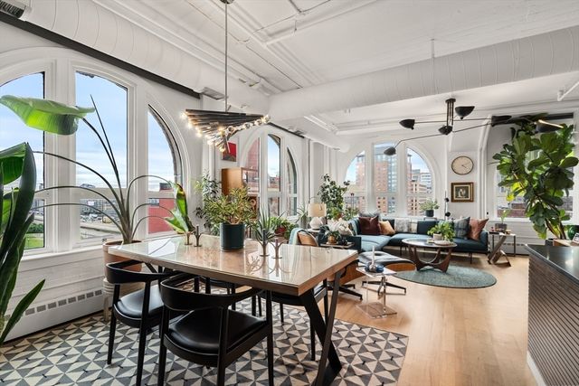 a living room with lots of furniture and a chandelier