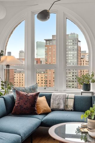a vase of flowers sitting on a table with a fireplace