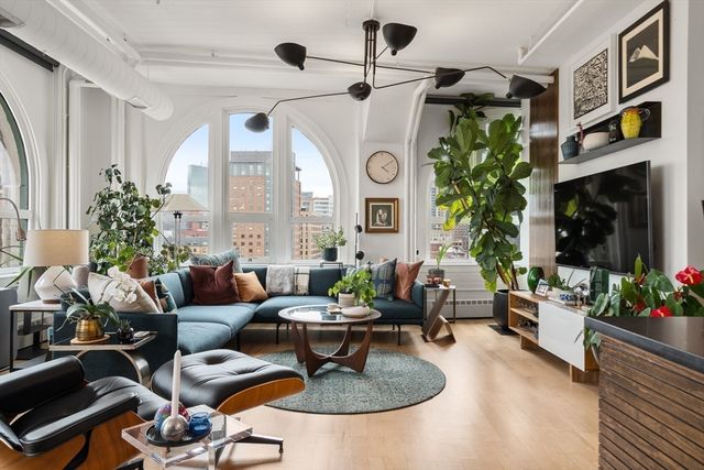 a living room with furniture and a potted plant