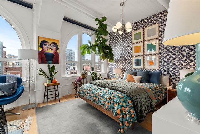 a bedroom with bed and a potted plant