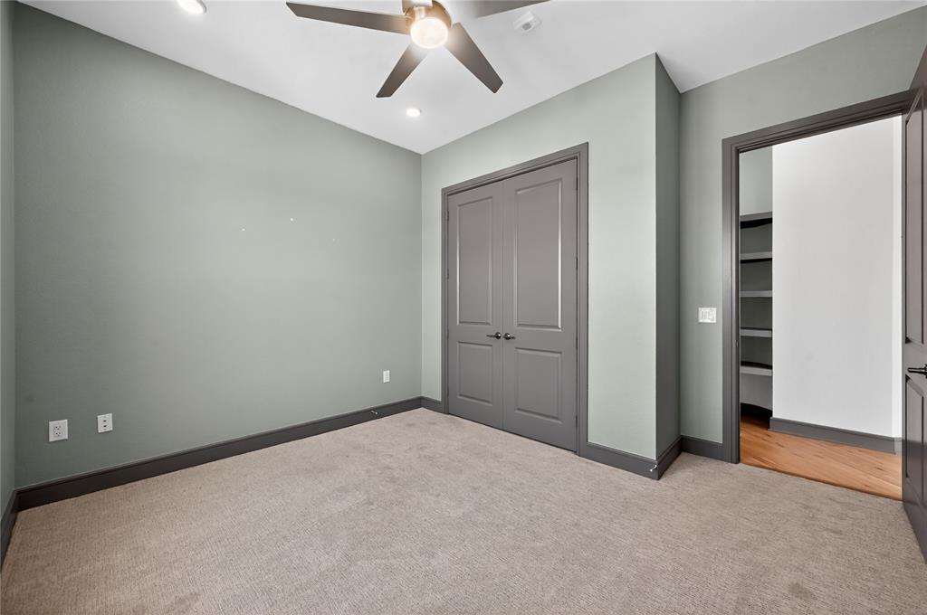 2700 Old Denton Road, Unit 2259 Carrollton, TX 75007 - Photo 27 of 39 an empty room with a ceiling fan and carpet