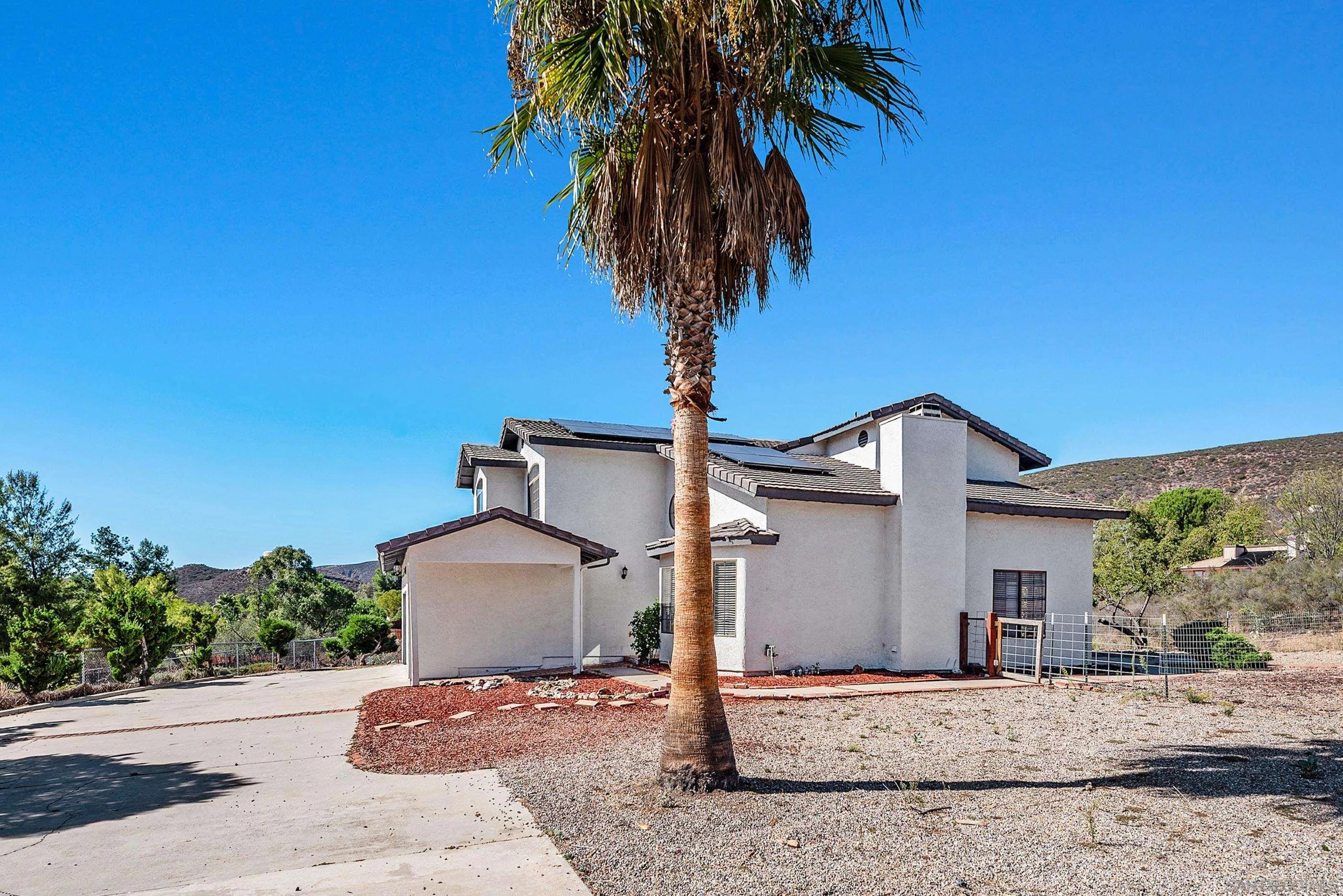 24252 Sargeant Road Ramona, CA 92065 - Photo 12 of 57 a front view of a house with a yard