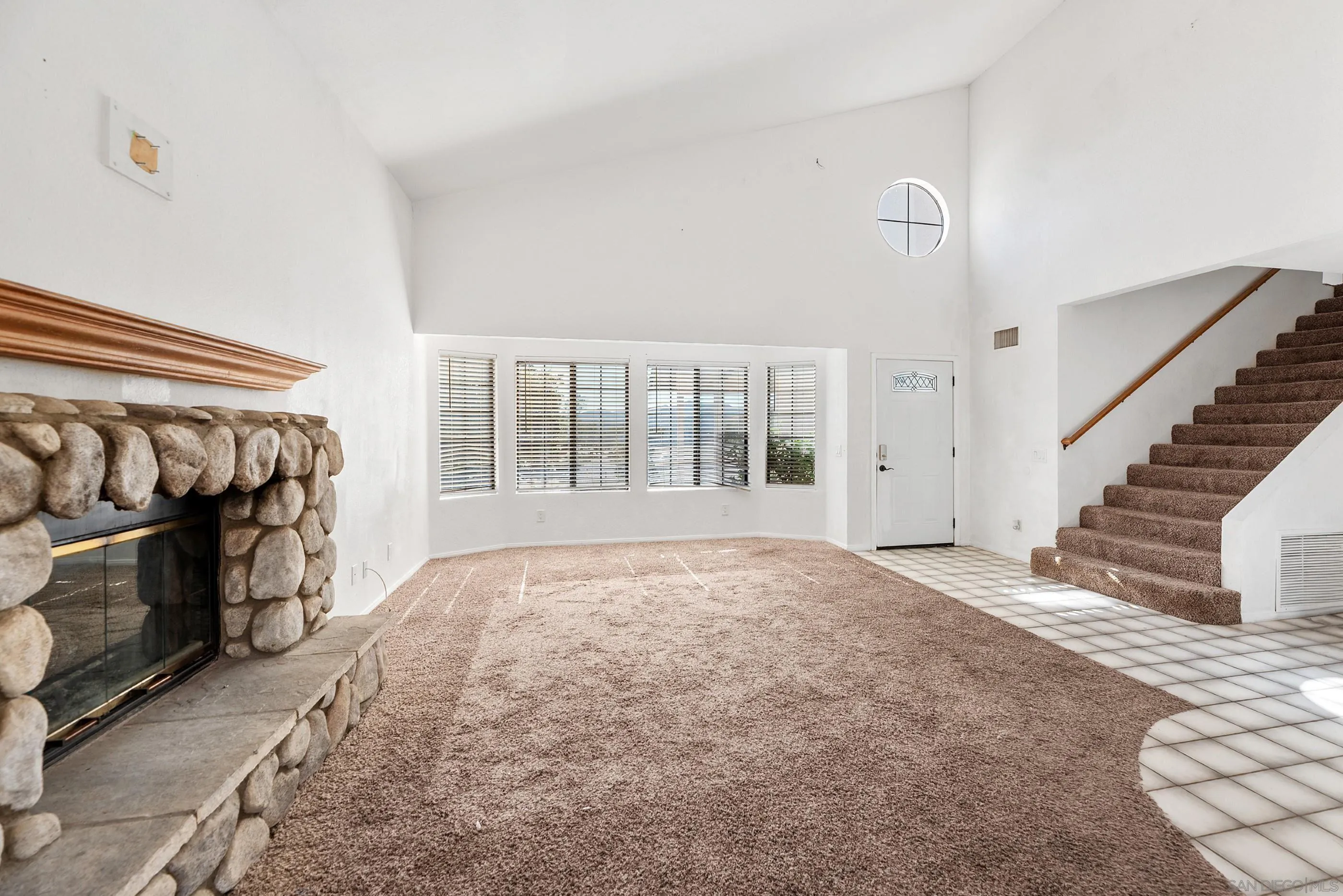 24252 Sargeant Road Ramona, CA 92065 - Photo 16 of 57 a view of an empty room with wooden floor and a window