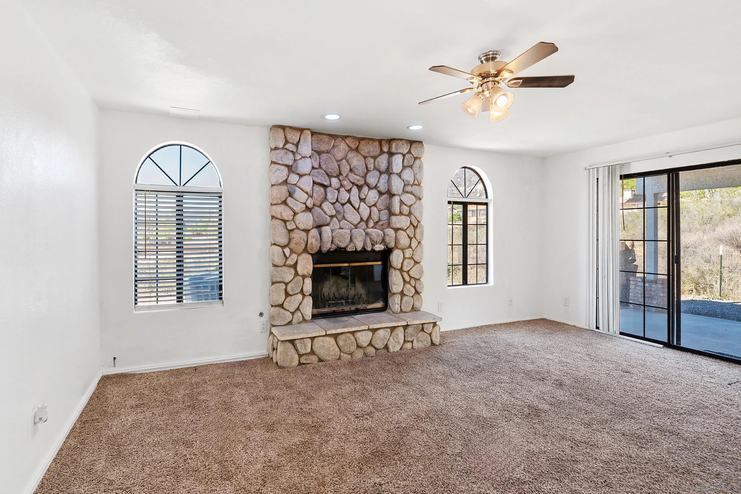 24252 Sargeant Road Ramona, CA 92065 - Photo 21 of 57 an empty room with windows and fireplace