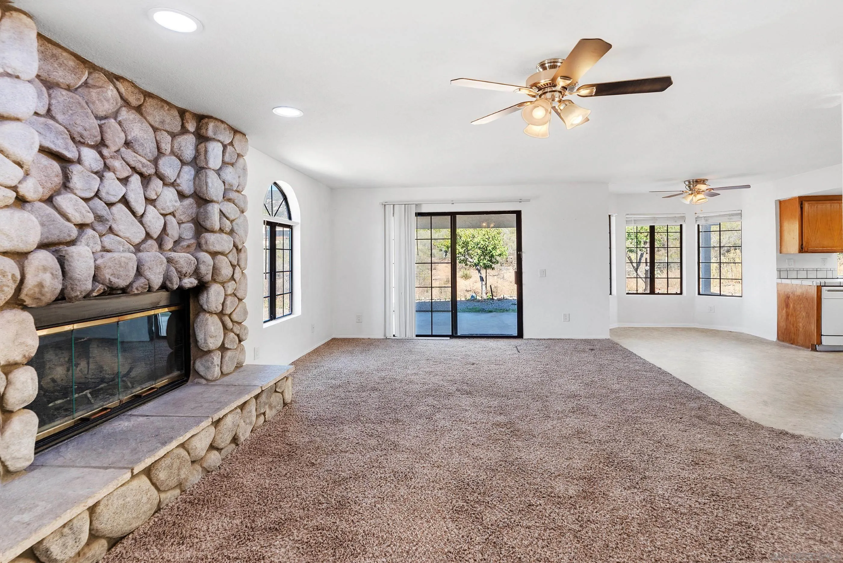24252 Sargeant Road Ramona, CA 92065 - Photo 22 of 57 a view of an empty room with a fireplace and a window