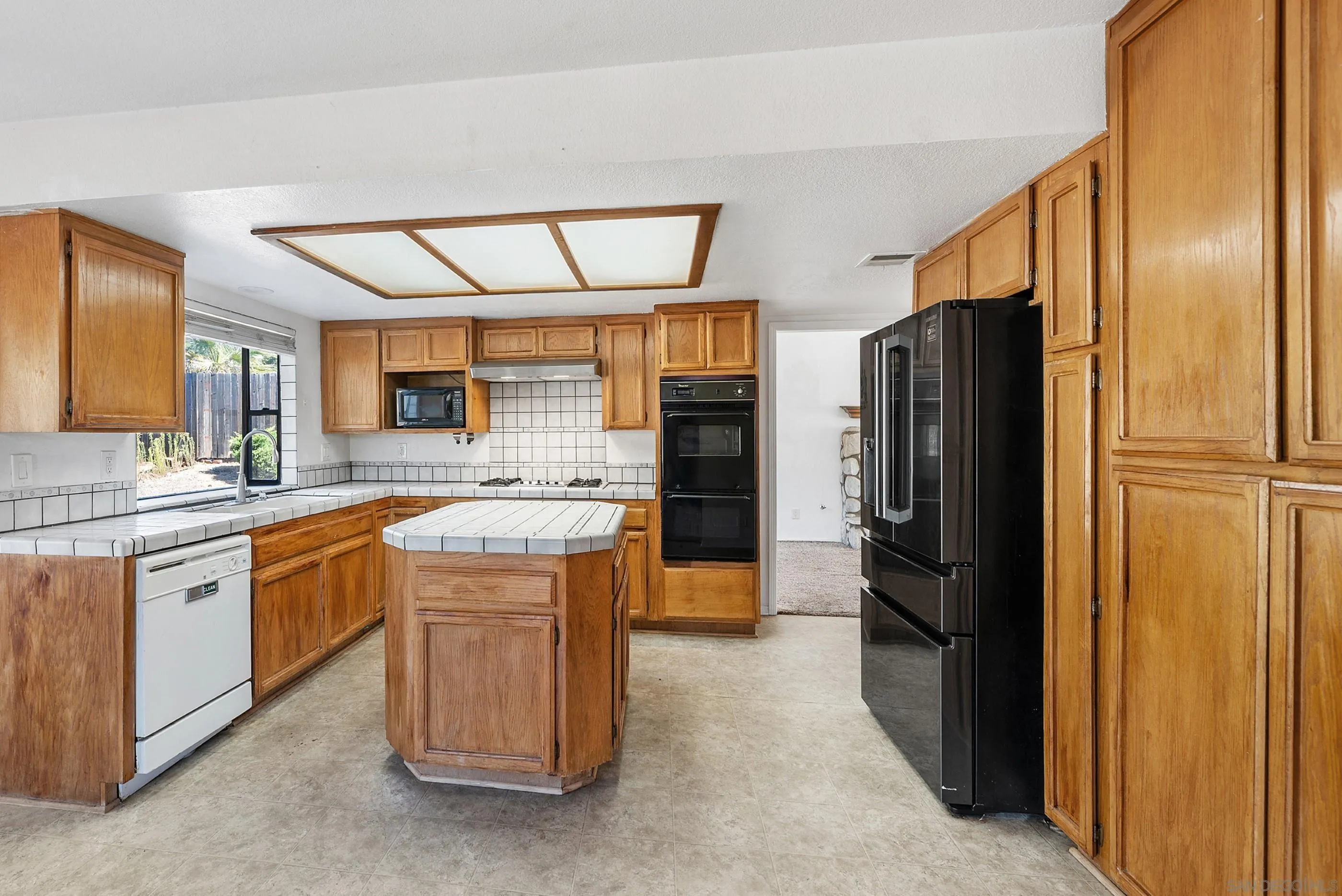 24252 Sargeant Road Ramona, CA 92065 - Photo 26 of 57 a kitchen with stainless steel appliances granite countertop a refrigerator and a sink