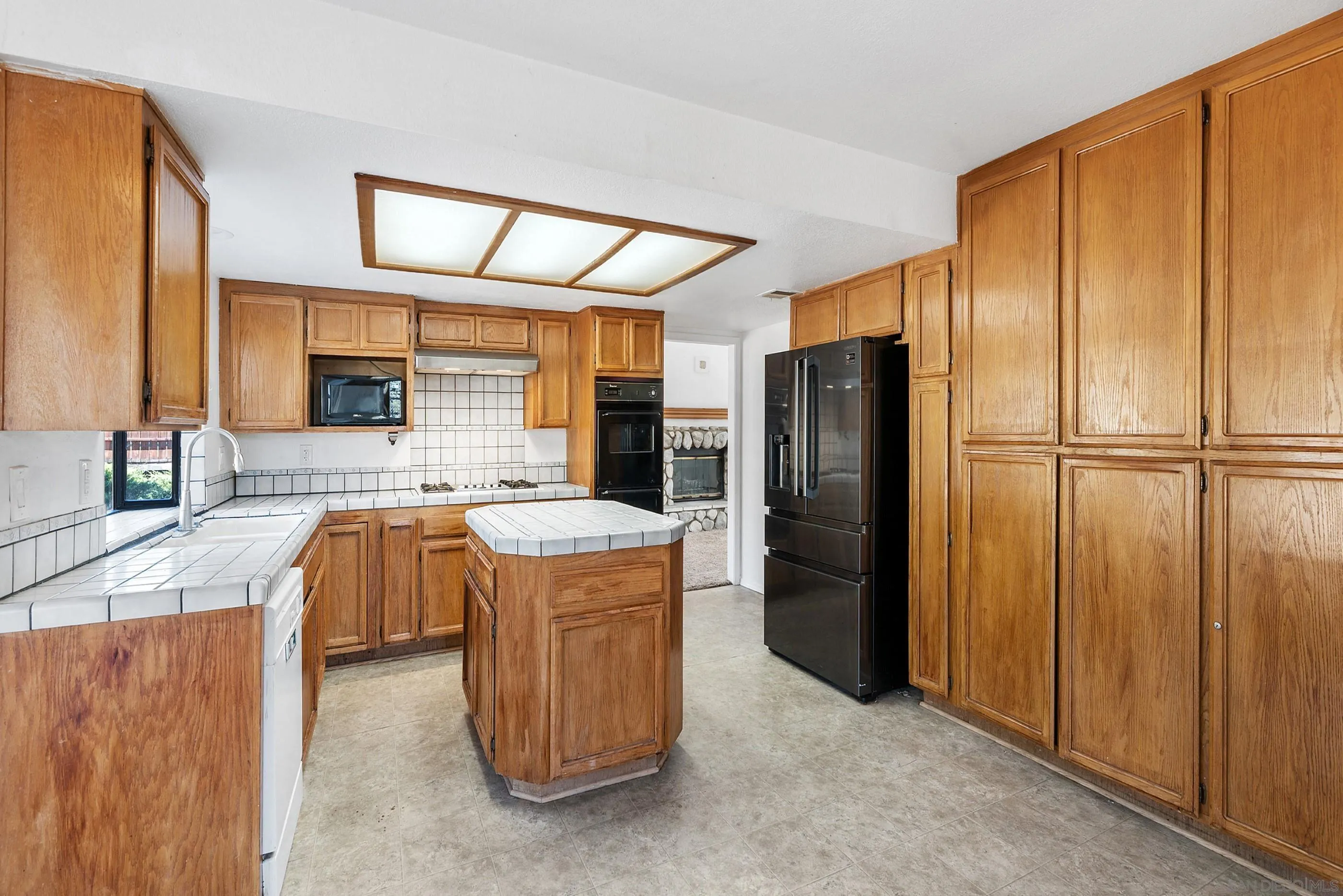 24252 Sargeant Road Ramona, CA 92065 - Photo 27 of 57 a kitchen with stainless steel appliances granite countertop a refrigerator and a sink