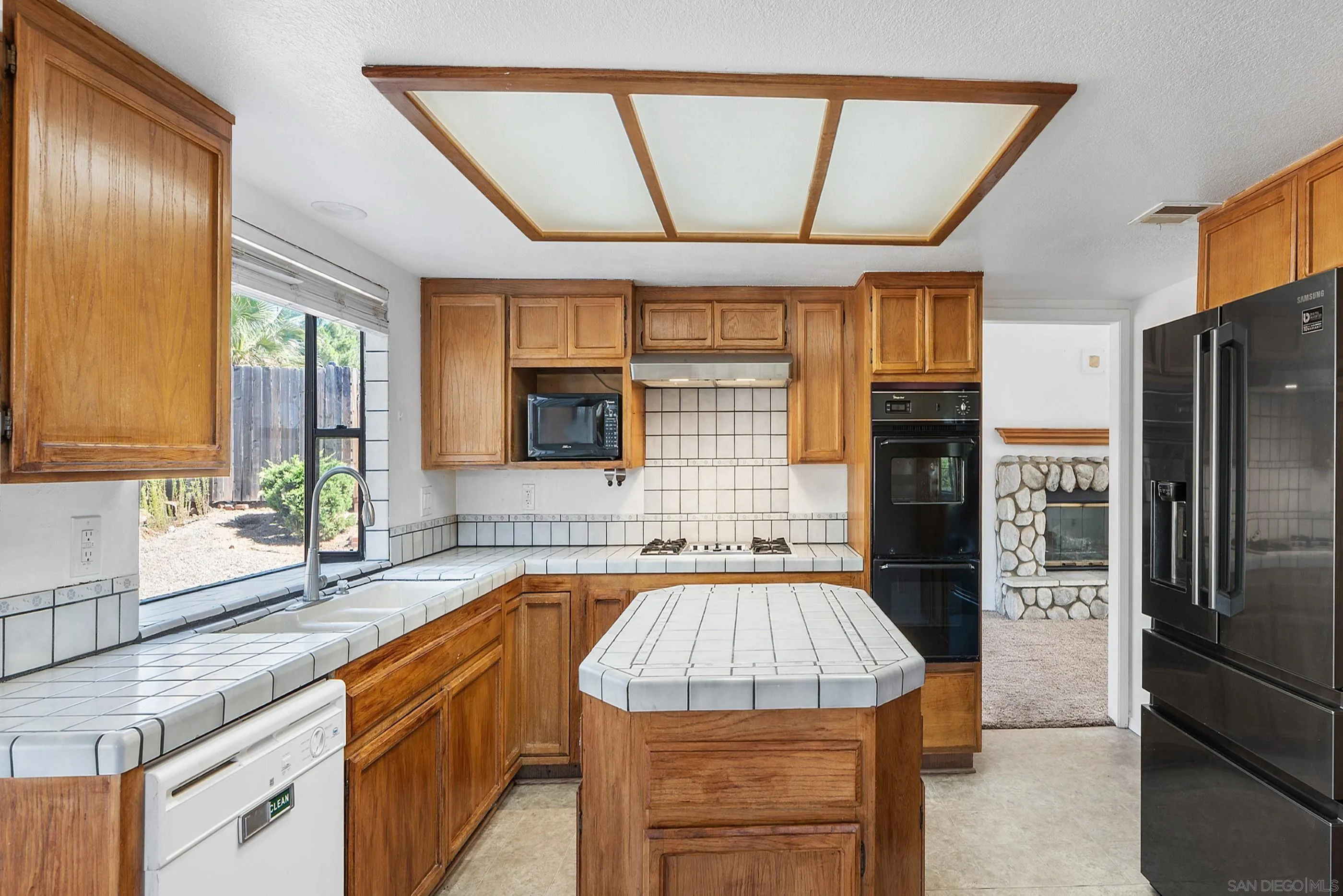 24252 Sargeant Road Ramona, CA 92065 - Photo 28 of 57 a kitchen with a sink appliances and cabinets