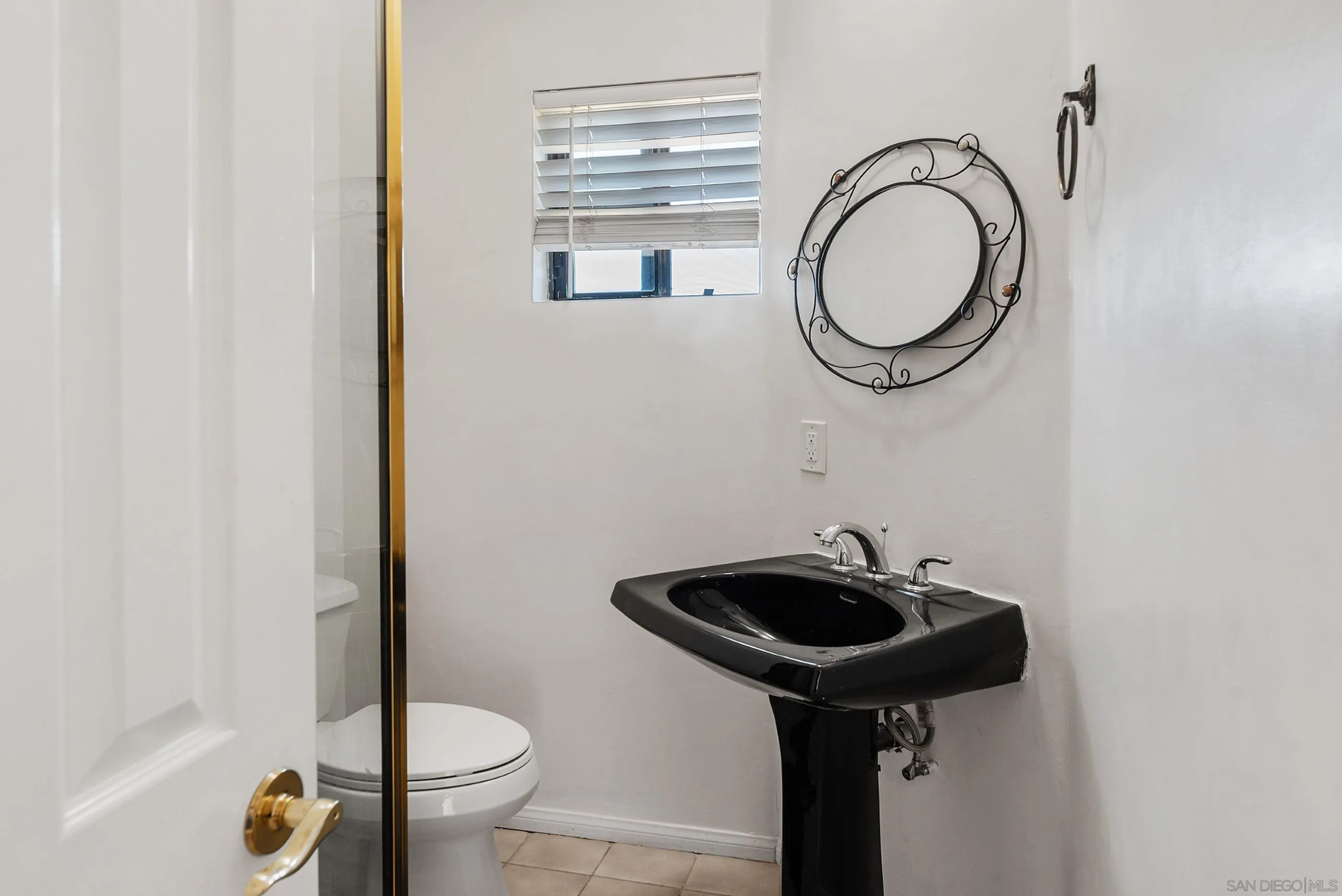 24252 Sargeant Road Ramona, CA 92065 - Photo 29 of 57 a bathroom with a sink and a mirror