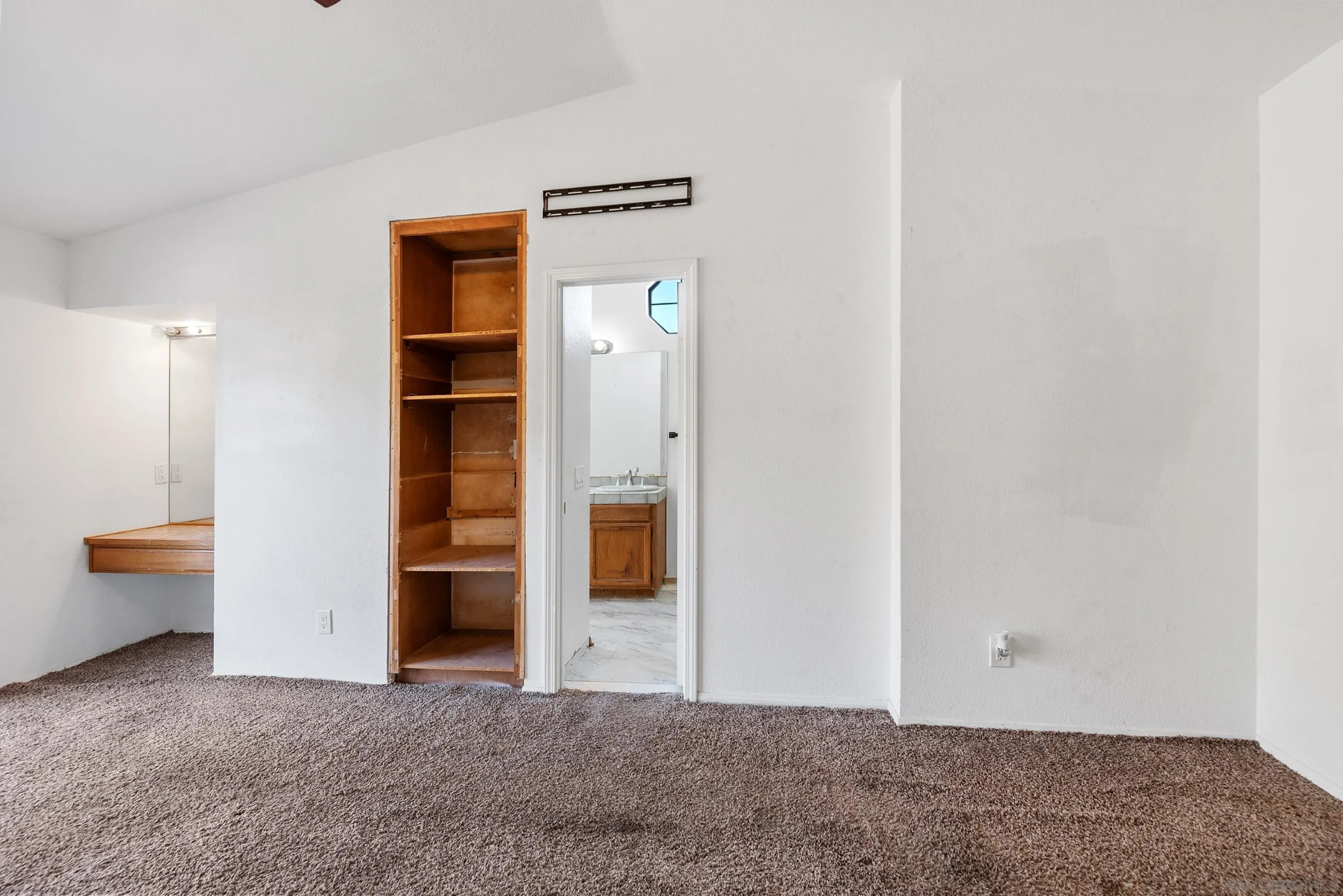 24252 Sargeant Road Ramona, CA 92065 - Photo 34 of 57 an empty room with closet and mirror