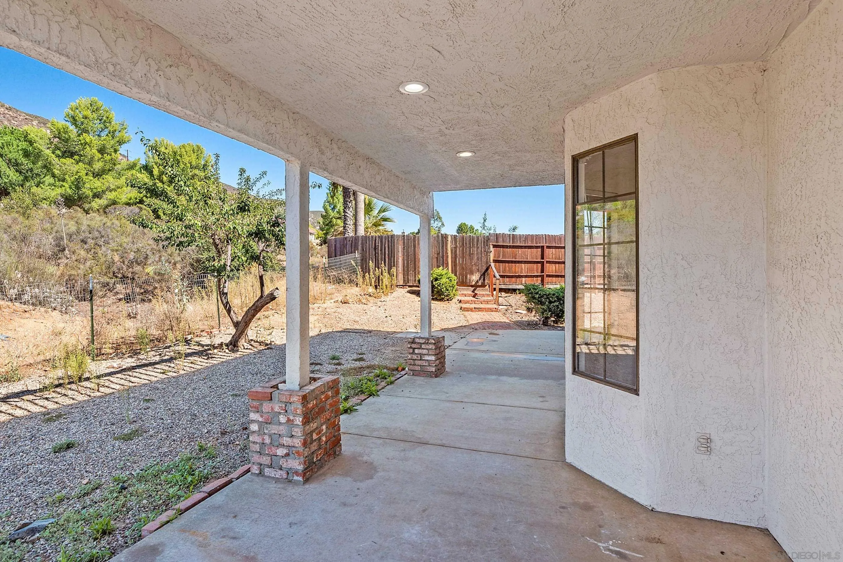24252 Sargeant Road Ramona, CA 92065 - Photo 45 of 57 a view of a porch with a bench