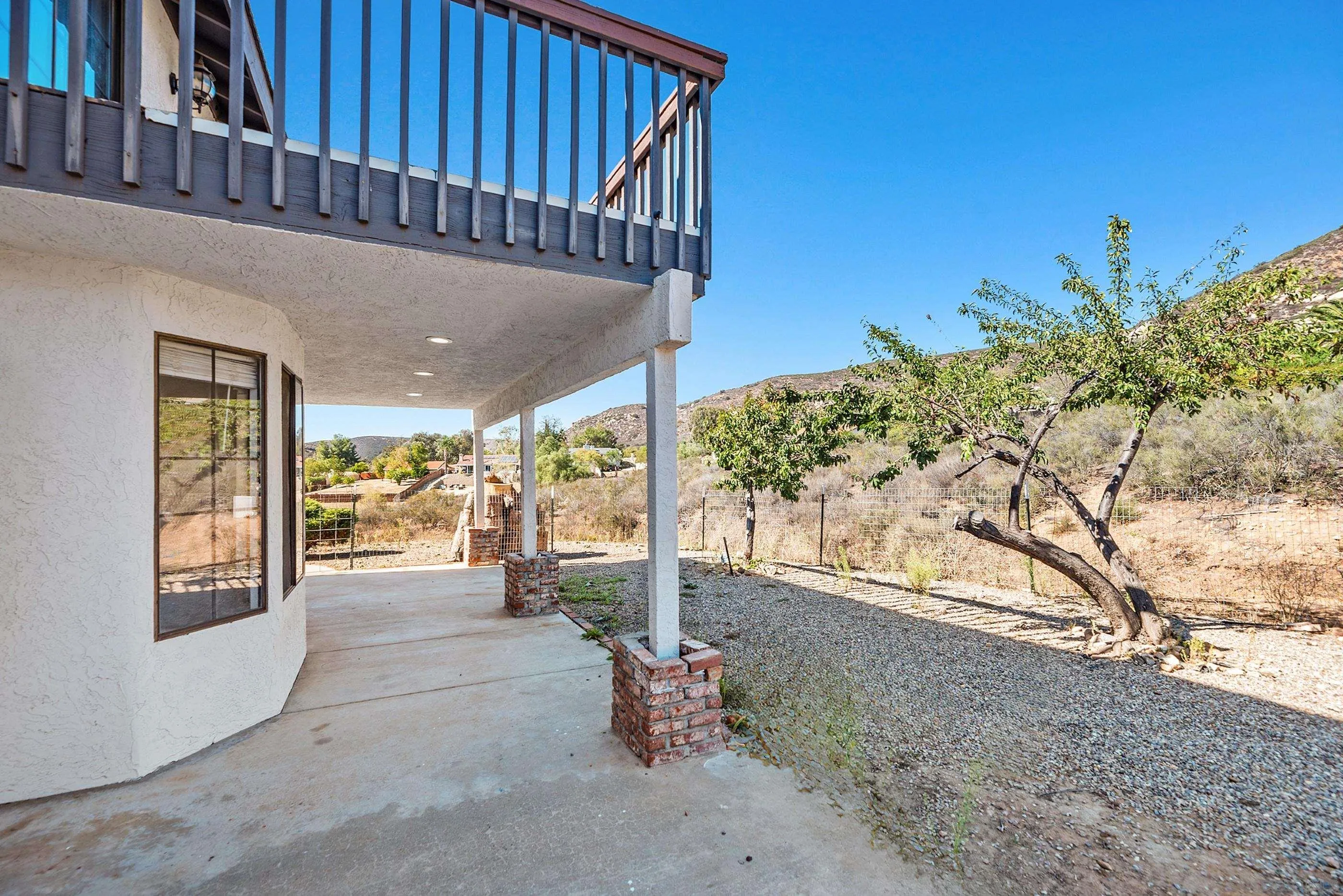 24252 Sargeant Road Ramona, CA 92065 - Photo 47 of 57 a view of a porch with furniture and floor to ceiling window