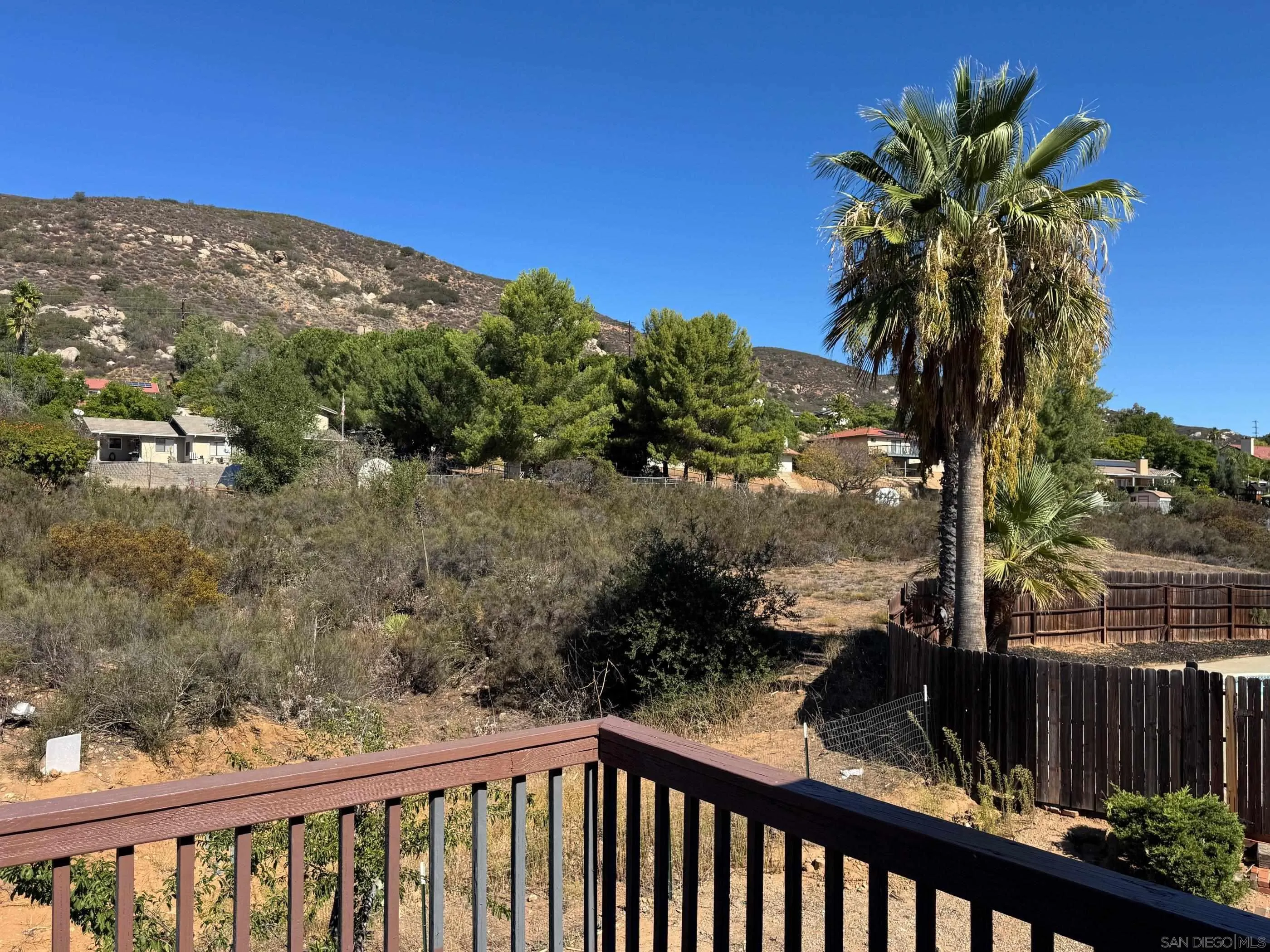 24252 Sargeant Road Ramona, CA 92065 - Photo 52 of 57 a view of a balcony with a floor to ceiling window and tree
