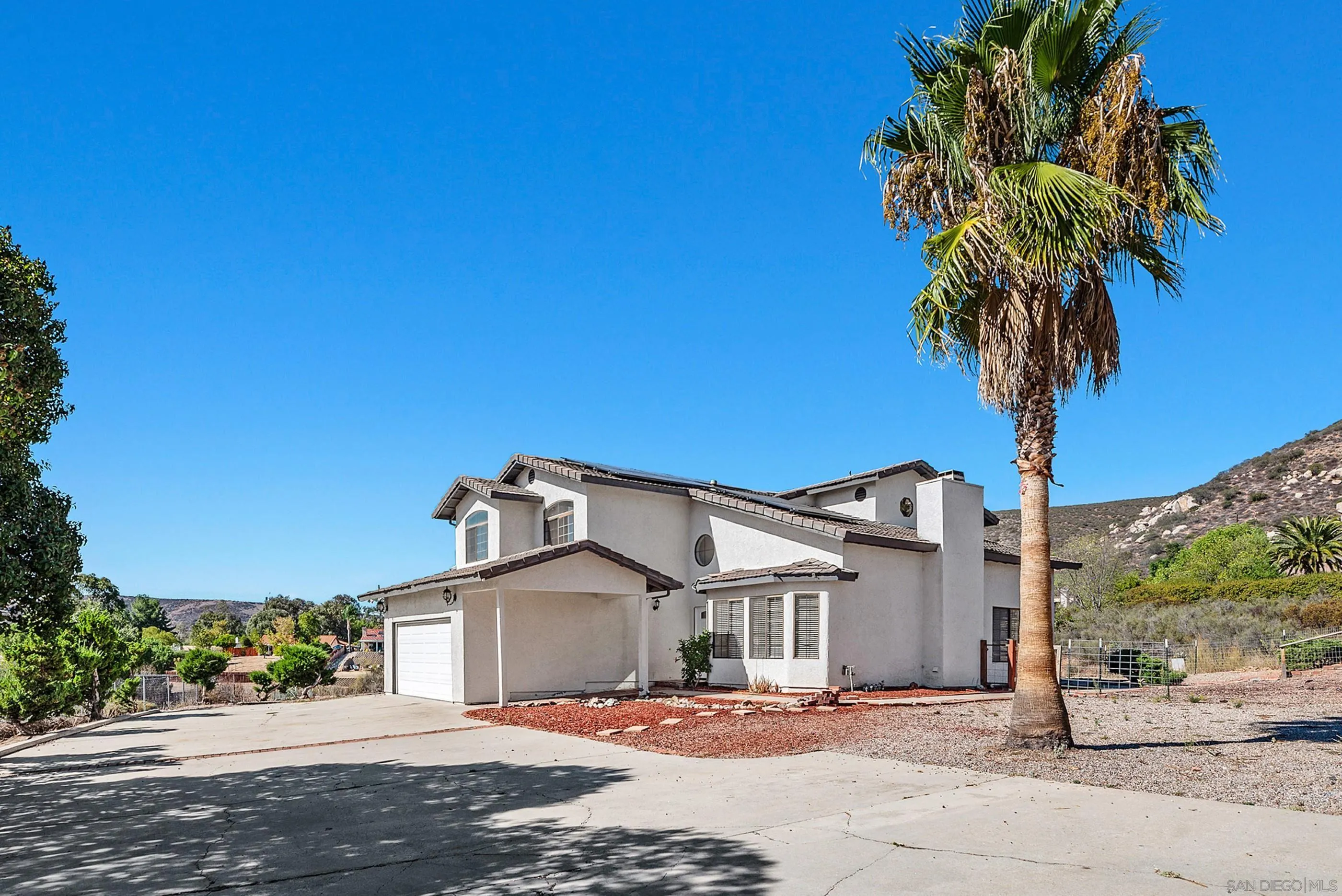 24252 Sargeant Road Ramona, CA 92065 - Photo 10 of 57 a front view of a house with a yard and garage