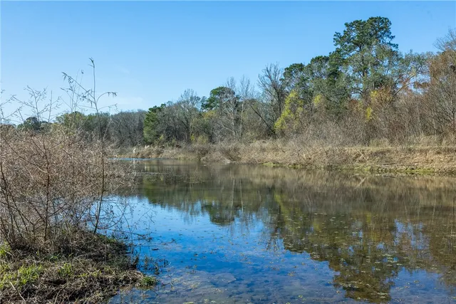 a view of a lake with green space
