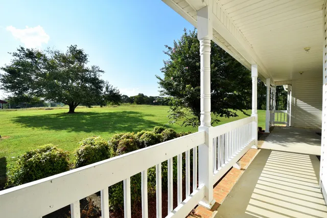 a kitchen with stainless steel appliances kitchen island granite countertop a refrigerator and a stove top oven