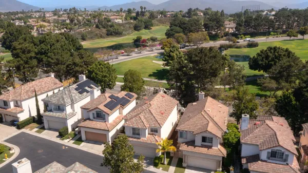 an aerial view of residential houses with outdoor space