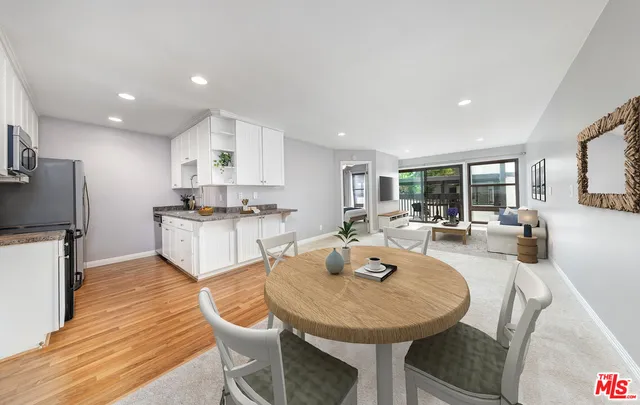 a view of a dining room with furniture and a wooden floor