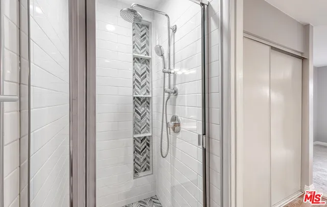 a bathroom with a shower and a door