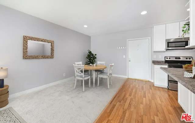 a dining room with furniture and wooden floor