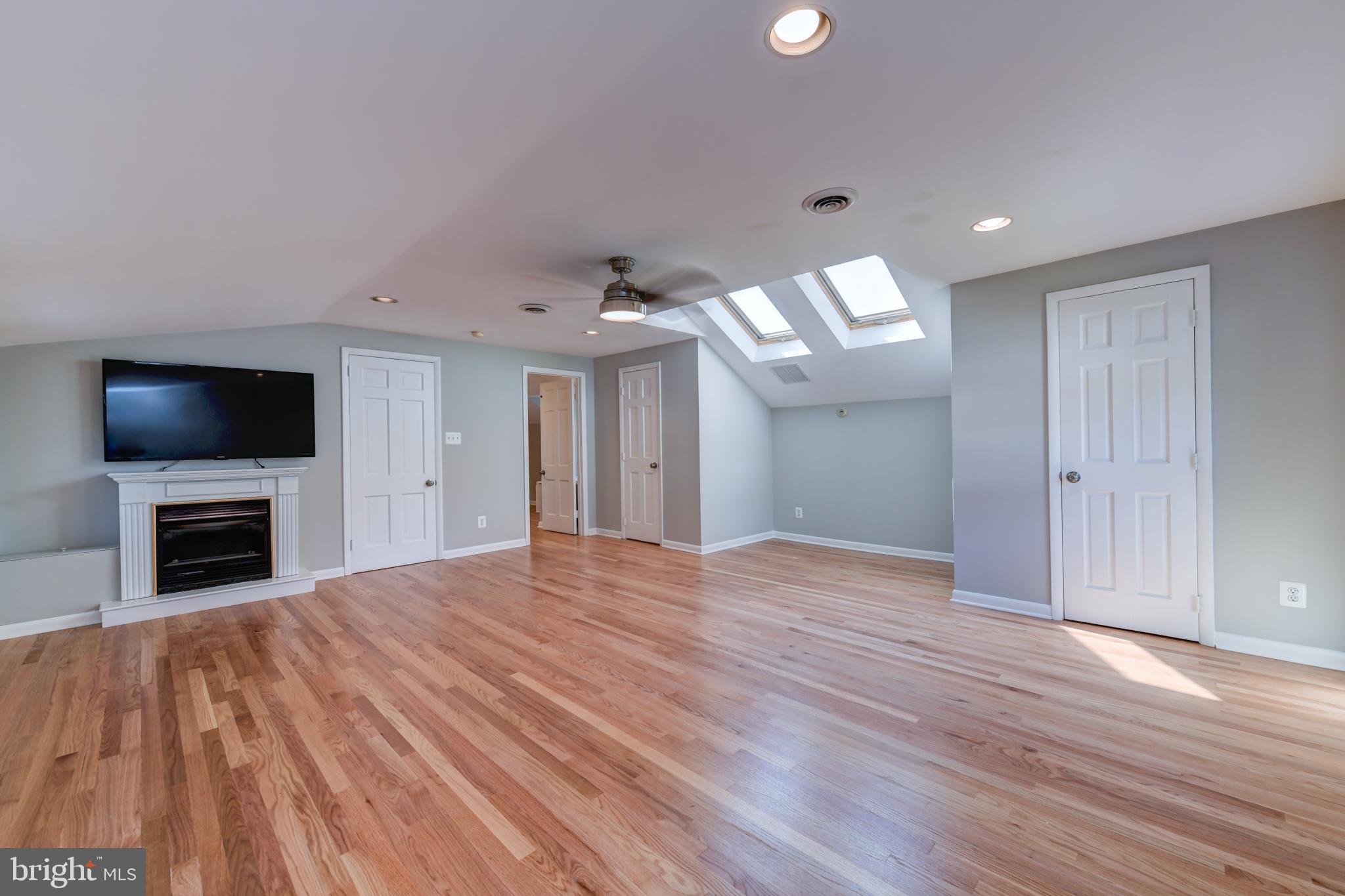 1165 Beverly Road Jenkintown, PA 19046 - Photo 17 of 31 a view of a livingroom with a flat screen tv wooden floor and staircase