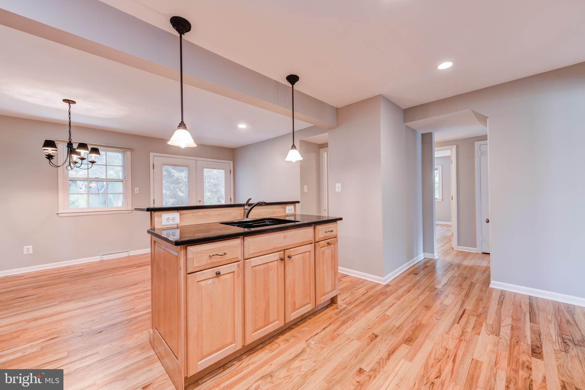 1165 Beverly Road Jenkintown, PA 19046 - Photo 7 of 31 a kitchen with stainless steel appliances granite countertop wooden floors sink and cabinets